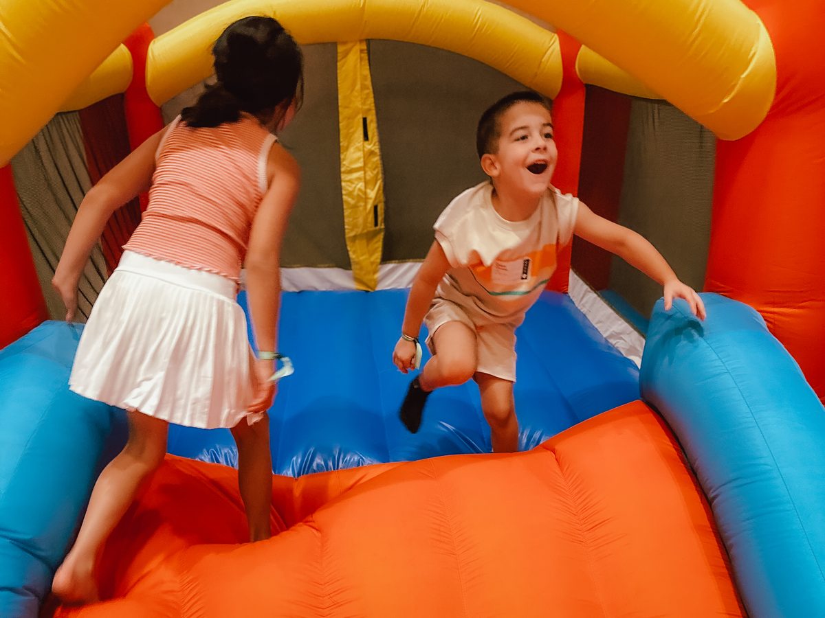 Two kids bouncing inside an inflatable