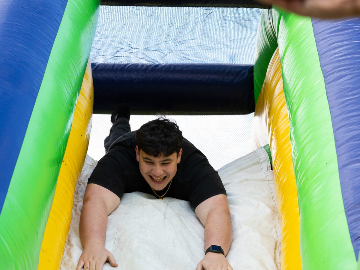 A kid sliding down a giant inflatable slide
